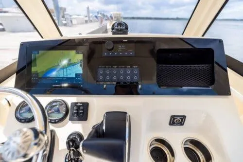 Slide: The Image of 2024 Scout 215XSF boat dashboard with navigation system and controls. - 2
