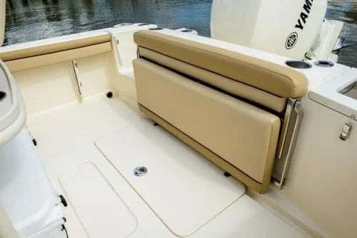 Slide: The Image of 2024 Scout 215XSF boat interior with tan seating and Yamaha engine. - 7