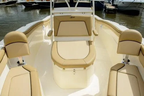 Slide: The Image of 2024 Scout 215XSF boat interior with beige seating and storage compartments. - 9
