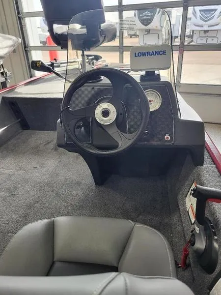 Slide: The Image of 2024 Tracker CLASSIC XL boat interior with steering wheel and Lowrance fish finder. - 5