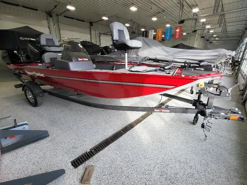 Slide: The Image of 2024 Tracker CLASSIC XL red fishing boat on trailer in showroom. - 6