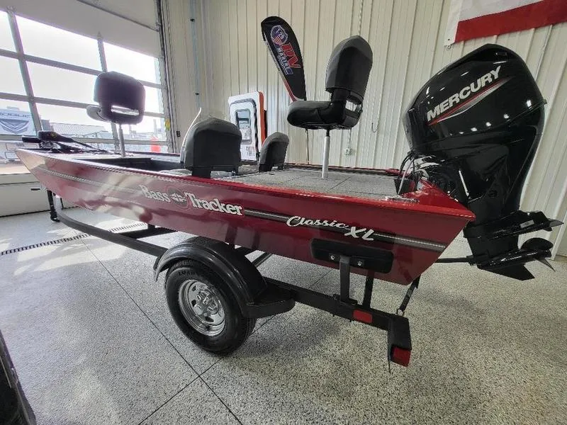 Slide: The Image of 2024 Tracker Classic XL boat with Mercury outboard motor in showroom. - 8