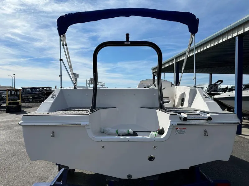 Slide: The Image of 2024 Starcraft SVX 171 OB boat rear view with blue canopy. - 2