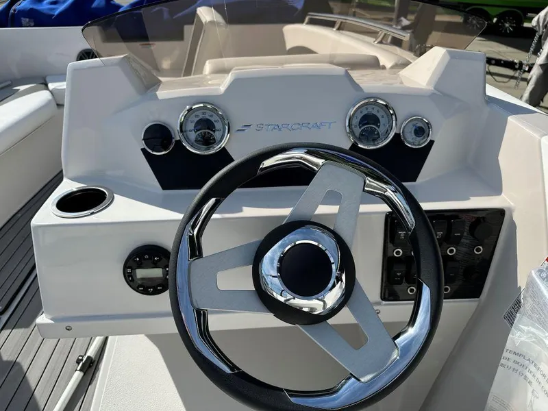 Slide: The Image of 2024 Starcraft SVX 171 OB boat dashboard with steering wheel and gauges. - 6