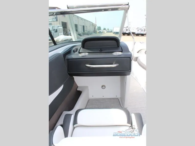Slide: The Image of 2023 Crownline 240 SS boat interior, featuring helm station and seating. - 11