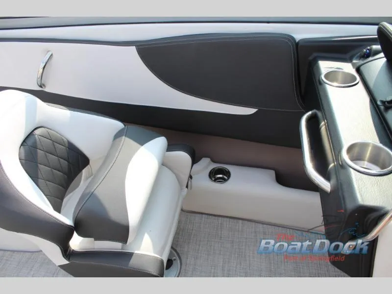 Slide: The Image of 2023 Crownline 240 SS boat interior with black and white seating and cup holders. - 12