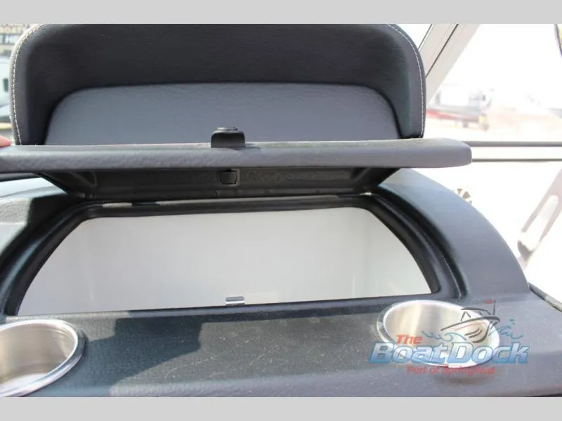 Slide: The Image of Open storage compartment in 2023 Crownline 240 SS boat with cup holders. - 13
