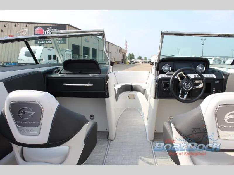 Slide: The Image of 2023 Crownline 240 SS boat interior with dual captain's chairs and modern dashboard. - 4