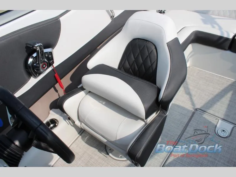 Slide: The Image of 2023 Crownline 240 SS boat interior with black and white captain's seat. - 9