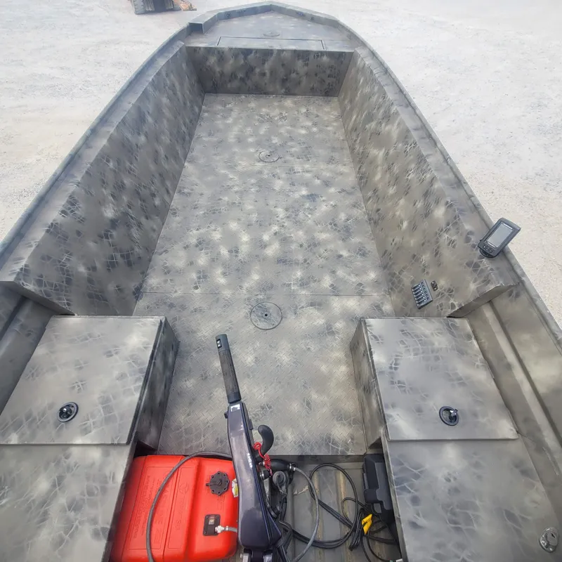 Slide: The Image of 2021 WeldBilt 2170 aluminum boat interior with camouflage pattern and storage compartments. - 11