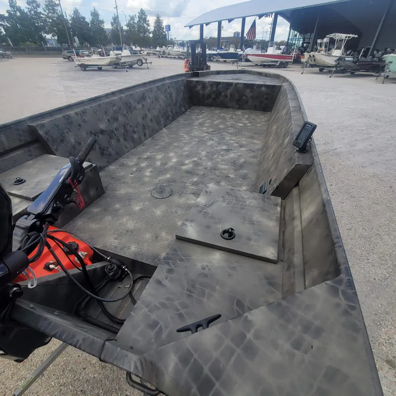 Slide: The Image of 2021 WeldBilt 2170 aluminum boat with camouflage interior, docked at a marina. - 8