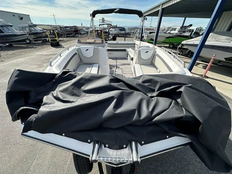 Slide: The Image of 2024 Starcraft SVX 191 OB boat at a marina, partially covered. - 3
