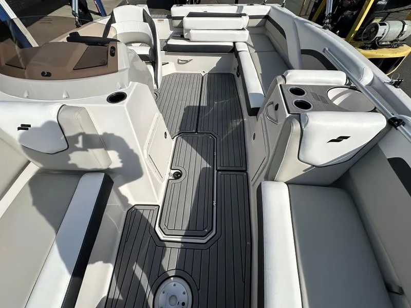 Slide: The Image of 2024 Starcraft SVX 191 OB boat interior with white seating and gray flooring. - 6