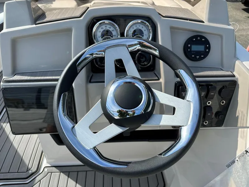 Slide: The Image of 2024 Starcraft SVX 191 OB boat dashboard with steering wheel and gauges. - 7