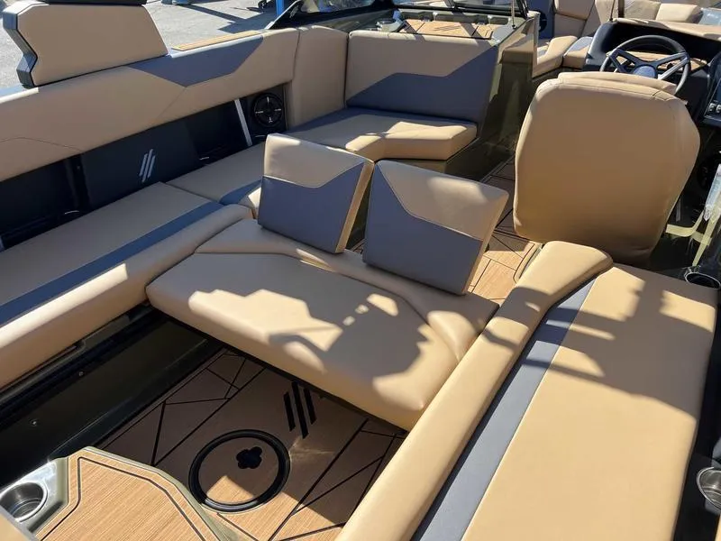 Slide: The Image of 2024 ATX Surf Boats 24 Type-S interior with tan and gray seating. - 12