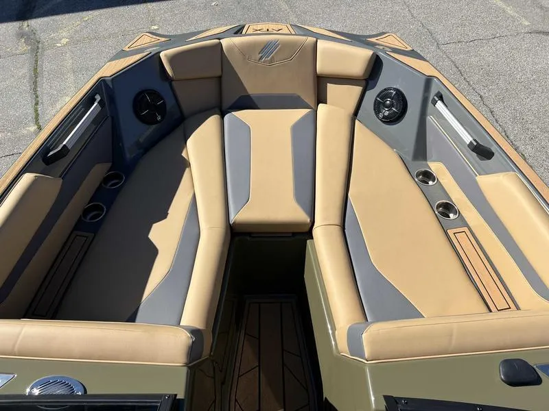 Slide: The Image of 2024 ATX Surf Boats 24 Type-S interior seating area with tan and gray upholstery. - 15