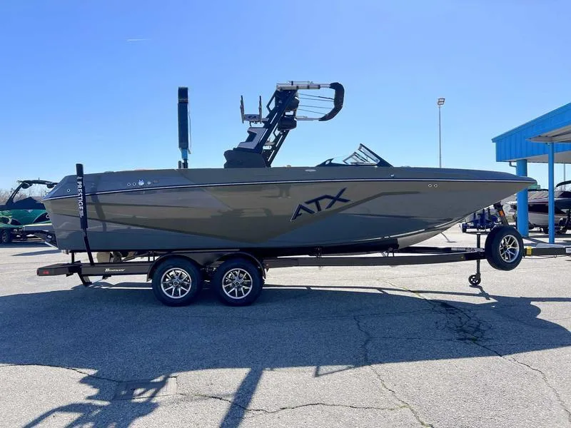 Slide: The Image of 2024 ATX Surf Boats 24 Type-S on trailer in outdoor lot. - 2