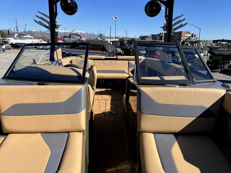 Slide: The Image of 2024 ATX Surf Boats 24 Type-S interior with tan and gray seating. - 8