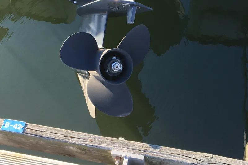 Slide: The Image of Propeller of a 1998 Stratos 2100 boat docked at a marina. - 11