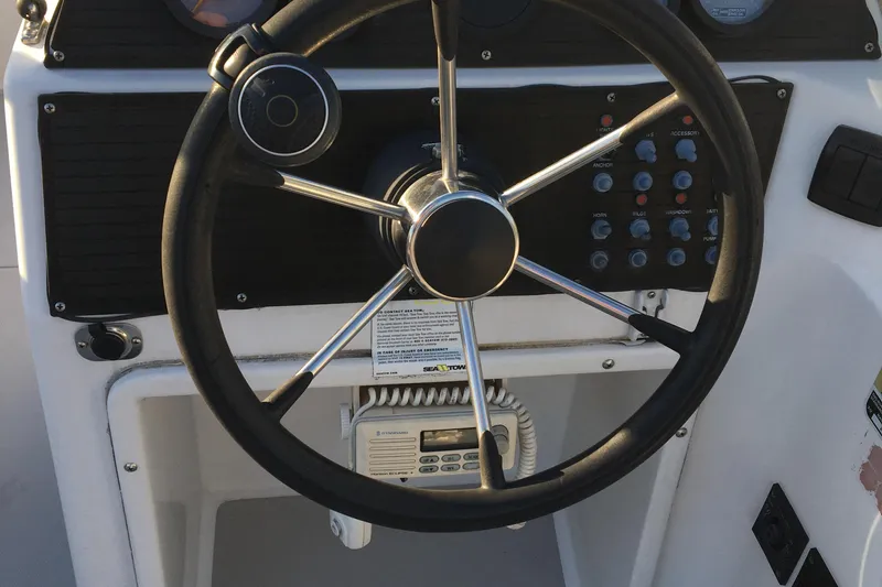 Slide: The Image of Steering wheel and control panel of a 1998 Stratos 2100 boat. - 17