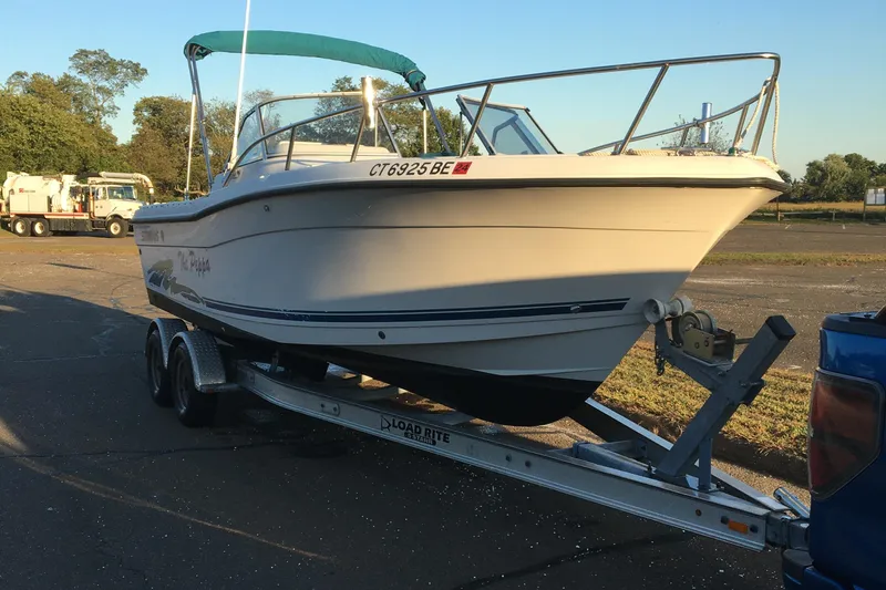Slide: The Image of 1998 Stratos 2100 boat on trailer in parking lot. - 19