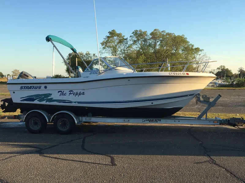 Slide: The Image of 1998 Stratos 2100 boat on trailer, side view, outdoors. - 7