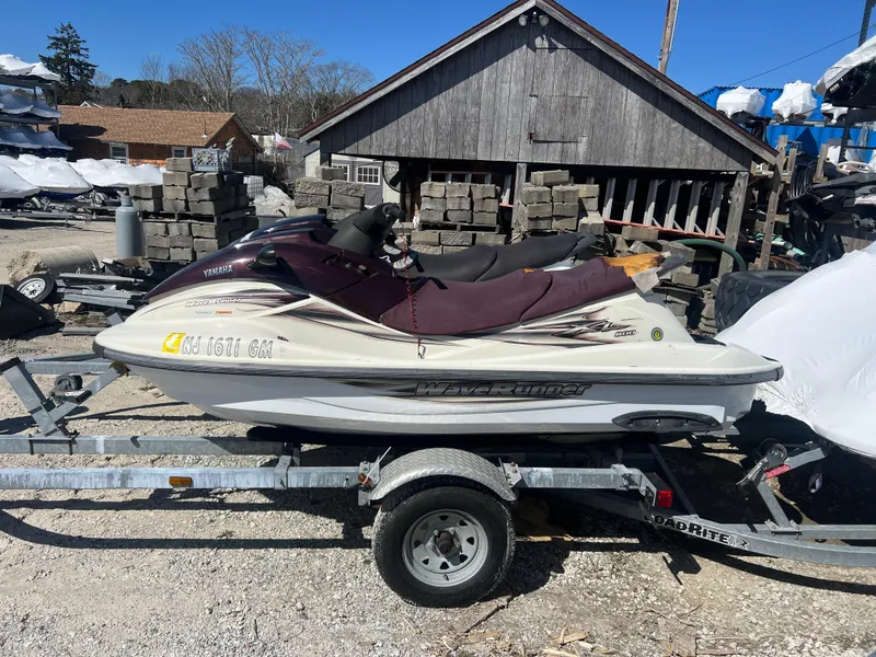 Slide: The Image of 2000 Yamaha WaveRunner XL 800 on trailer, parked outdoors near wooden building. - 7