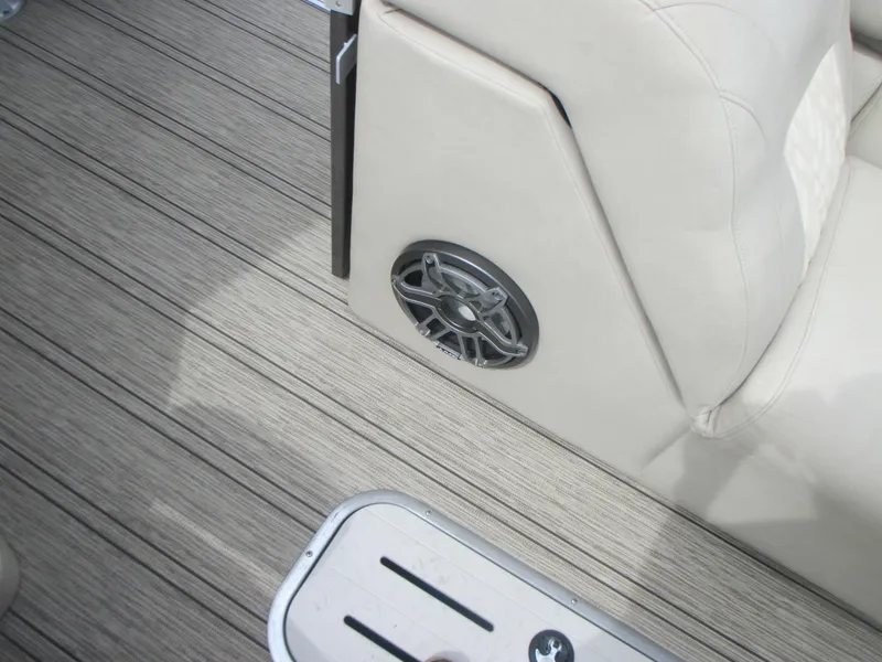 Slide: The Image of 2018 Premier 270 Intrigue RF boat interior with speaker and beige seating. - 10