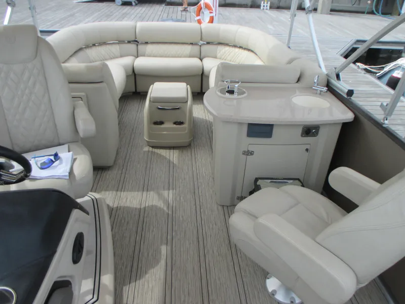 Slide: The Image of 2018 Premier 270 Intrigue RF boat interior with beige seating and table. - 11