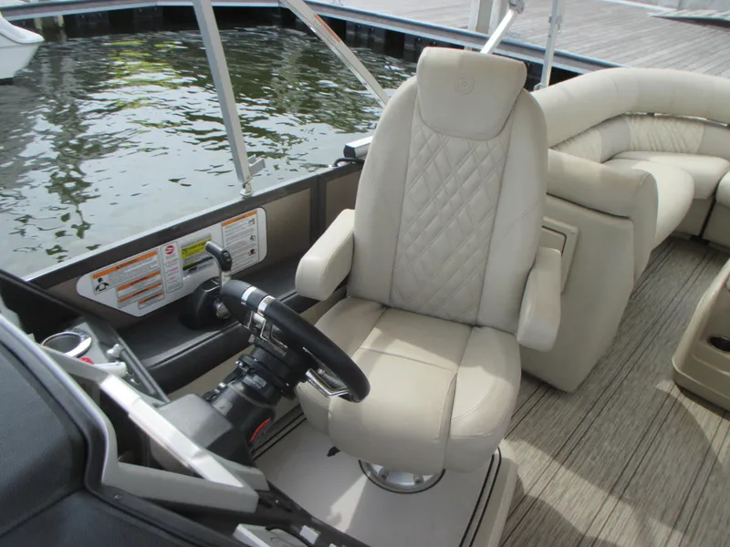 Slide: The Image of Captain's chair and helm of 2018 Premier 270 Intrigue RF pontoon boat. - 13