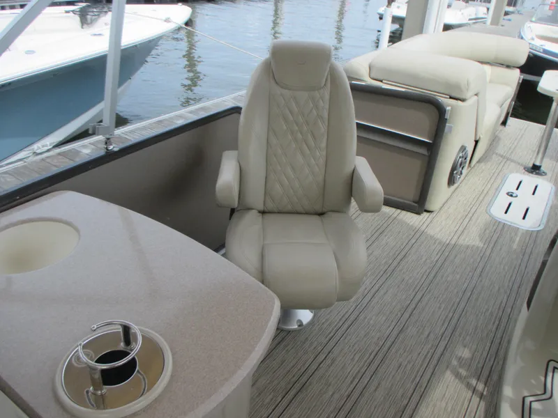 Slide: The Image of 2018 Premier 270 Intrigue RF boat interior with beige seating and table. - 14