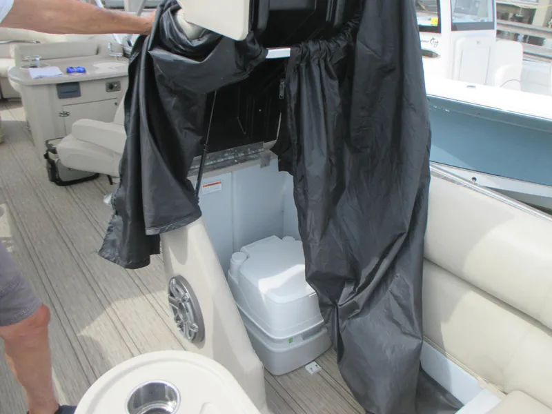 Slide: The Image of 2018 Premier 270 Intrigue RF boat interior with portable toilet and seating. - 18