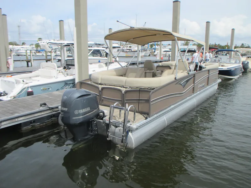 Slide: The Image of 2018 Premier 270 Intrigue RF pontoon boat docked with Yamaha outboard motor. - 3