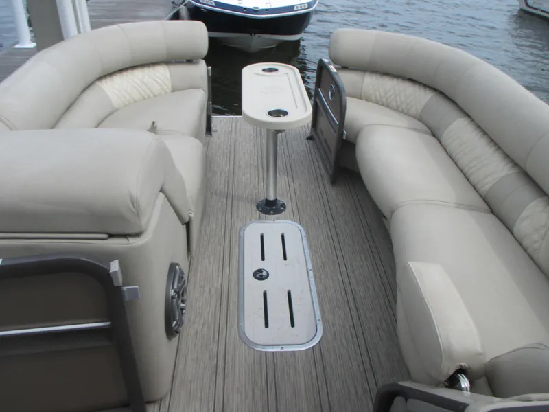 Slide: The Image of 2018 Premier 270 Intrigue RF boat interior with beige seating and table. - 6