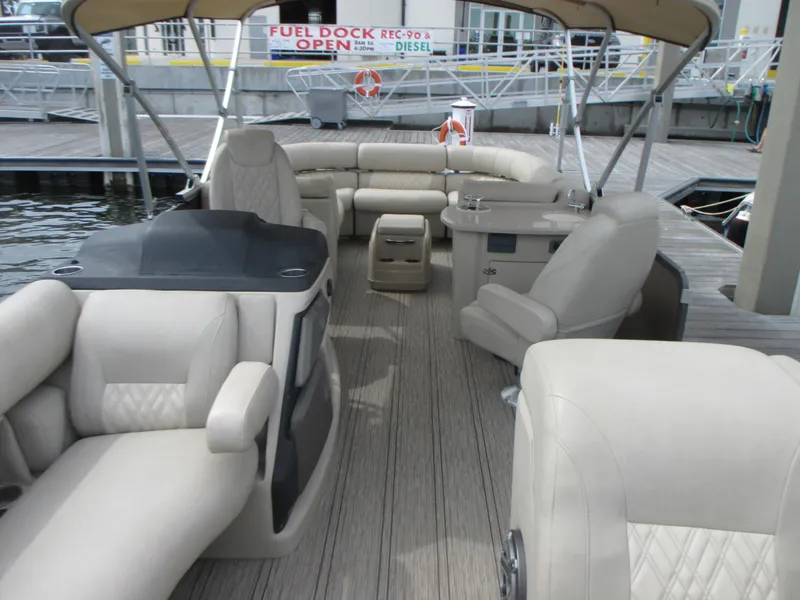 Slide: The Image of 2018 Premier 270 Intrigue RF pontoon boat with beige interior at dock. - 9