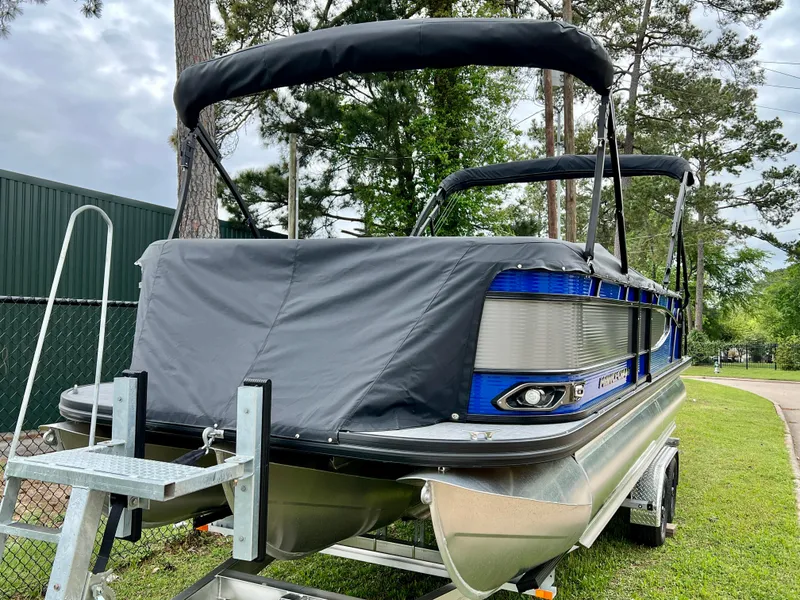 Slide: The Image of 2024 Princecraft Quorum 23 RL pontoon boat on trailer with cover. - 2