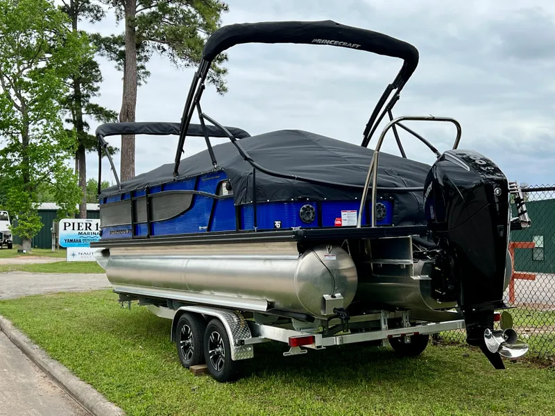 Slide: The Image of 2024 Princecraft Quorum 23 RL pontoon boat on a trailer, covered and ready for transport. - 4