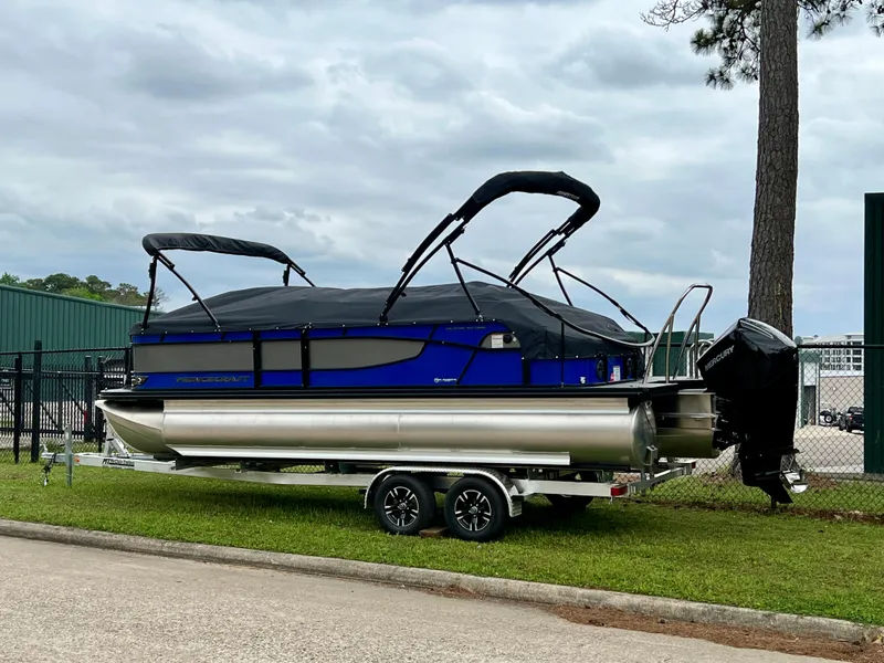 Slide: The Image of 2024 Princecraft Quorum 23 RL pontoon boat on a trailer. - 6