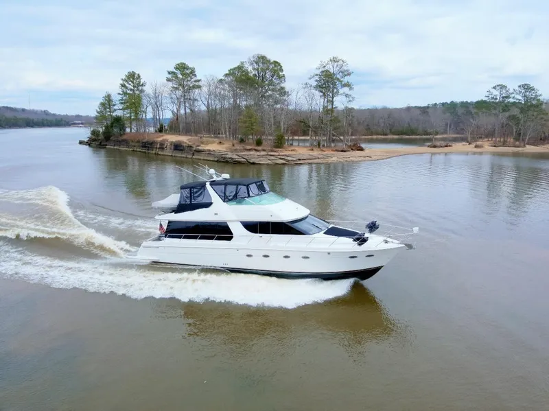 The Image of 2001 Carver 570 Voyager Pilothouse cruising on a serene lake. - 0