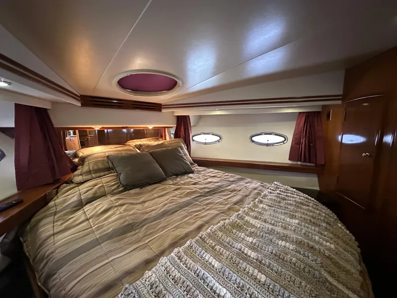 Slide: The Image of Luxurious bedroom in 2001 Carver 570 Voyager Pilothouse yacht with cozy bedding. - 13