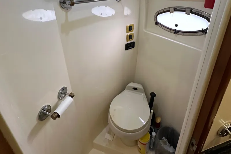 Slide: The Image of Compact bathroom in 2001 Carver 570 Voyager Pilothouse with toilet and porthole window. - 26