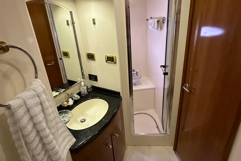 Slide: The Image of 2001 Carver 570 Voyager Pilothouse bathroom with sink, mirror, and shower. - 28