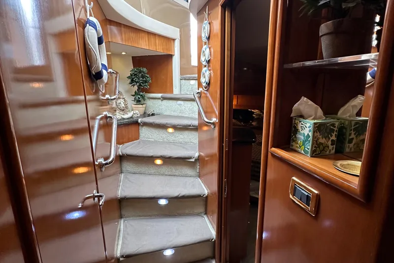 Slide: The Image of Interior stairs of 2001 Carver 570 Voyager Pilothouse yacht with wooden finish. - 29
