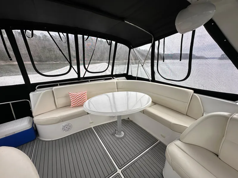 Slide: The Image of Interior seating area of 2001 Carver 570 Voyager Pilothouse yacht with round table. - 6