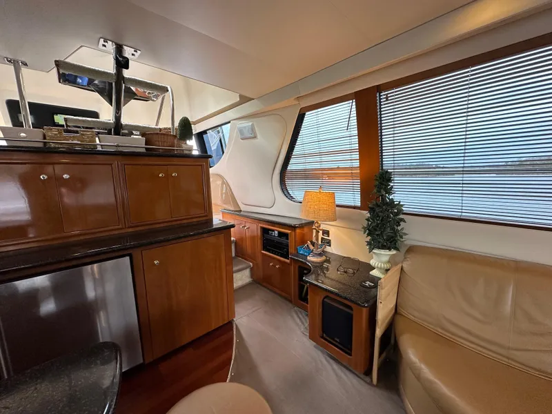 Slide: The Image of Interior of 2001 Carver 570 Voyager Pilothouse with wooden cabinetry and leather seating. - 10