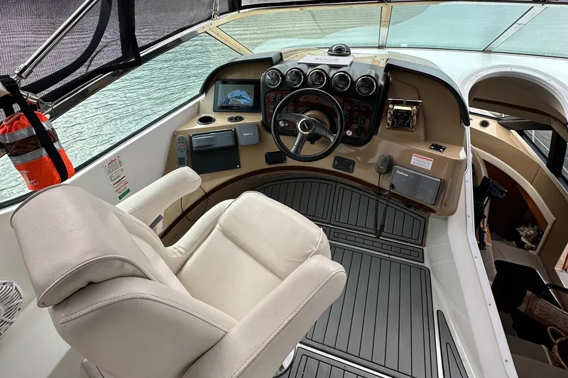 Slide: The Image of 2001 Carver 570 Voyager Pilothouse helm with captain's chair and navigation instruments. - 20