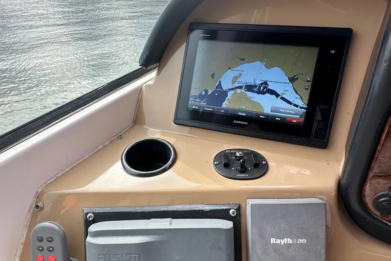 Slide: The Image of 2001 Carver 570 Voyager Pilothouse navigation system with Garmin display and Raytheon equipment. - 21