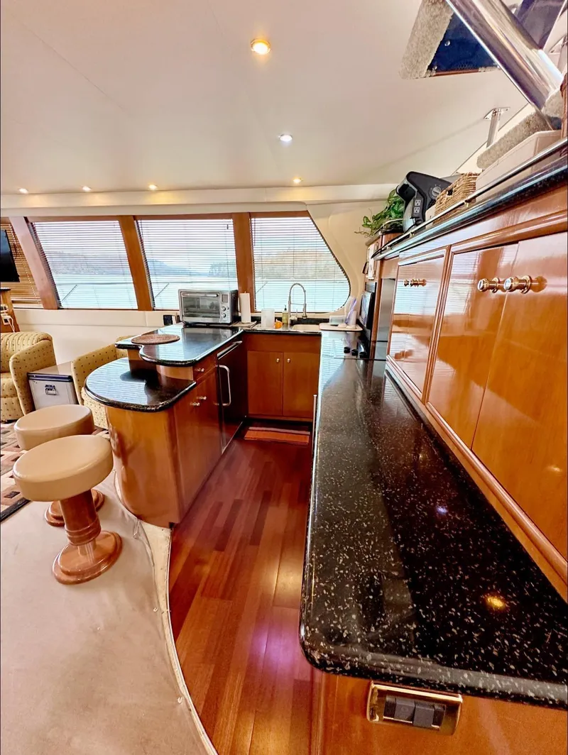 Slide: The Image of Luxurious kitchen area in a 2001 Carver 570 Voyager Pilothouse yacht. - 4