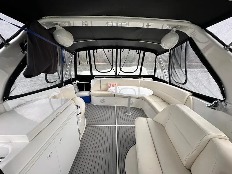 Slide: The Image of Interior of 2001 Carver 570 Voyager Pilothouse with white seating and table. - 7