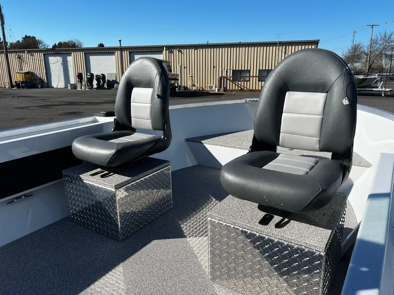 Slide: The Image of 2024 Fish Rite Angler 18 boat with two cushioned seats on diamond plate bases. - 12